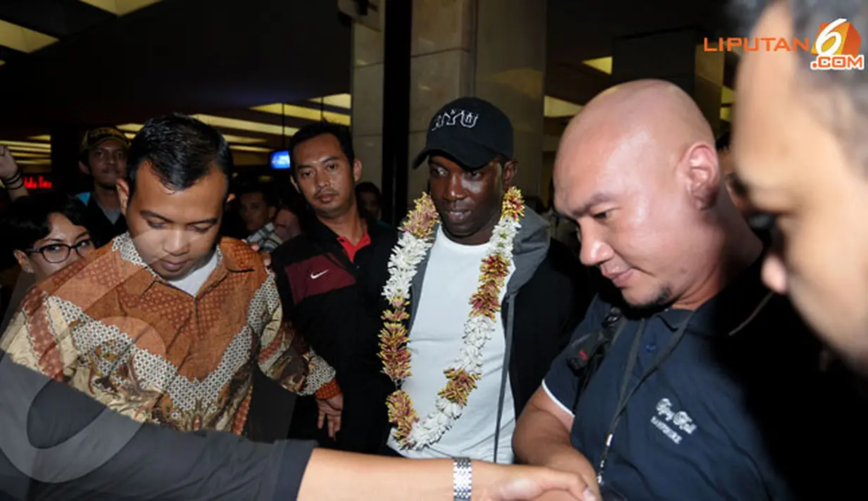 Dengan kawalan ketat petugas keamanan Dwight Yorke keluar dari Bandara Soekarno Hatta (Liputan6.com/Helmi Fithriansyah)