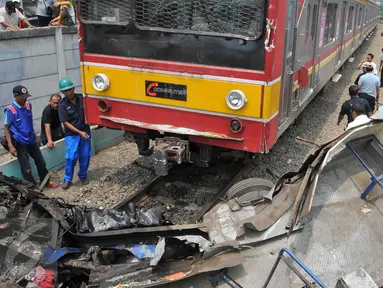 Metromini B 80 jurusan Grogol-Kalideres tertabrak di pintu perlintasan sebelum Stasiun Angke, Tambora, Jakarta Barat, Minggu (12/6/2015). Saksi menyebut Metromini tersebut nekat menerobos pintu perlintasan.(Liputan6.com/Gempur M Surya) 