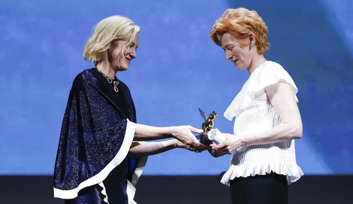 Aktris Tilda Swinton (kanan) menerima trofi Golden Lion for Lifetime Achievement dari Presiden Juri Cate Blanchett pada upacara pembukaan Venice Film Festival ke-77 di Venesia, Italia, Rabu (2/9/2020). Venice Film Festival tahun ini berlangsung dari 2-12 September. (AP Photo/Domenico Stinellis)