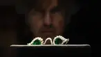 Seorang anggota staf melihat kacamata Mughal dengan lensa zamrud, dalam bingkai berlian, di Sotheby's, di London, Jumat (22/10/2021).  Kacamata berlian peninggalan era Mughal India sekitar tahun 1890 ini akan dilelang di rumah lelang Sotheby's. (AP Photo/Alberto Pezzali)