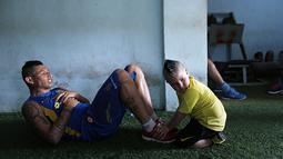 Fabio Escobar pemain Deportivo dibantu oleh anaknya yang berusia 3 tahun melakukan pemanasan.  (AP Photo/Jorge Saenz)