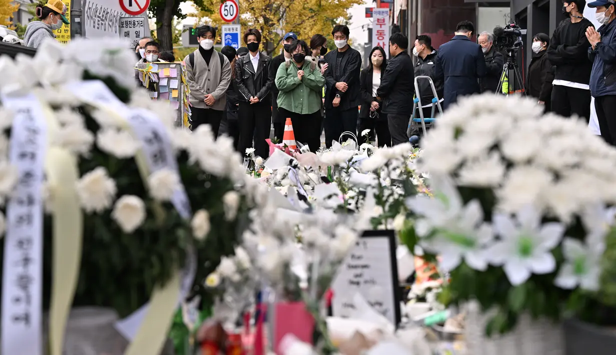 Pelayat memberikan penghormatan pada peringatan darurat untuk para korban akibat kerumunan massa dalam tragedi Halloween yang mematikan, di luar stasiun kereta bawah tanah di distrik Itaewon di Seoul, Kamis (3/11/2022). Tragedi perayaan halloween di distrik Itaewon, Korea Selatan, pada Sabtu, 19 November lalu menelan korban hingga 156 jiwa termasuk 26 warga asing. (Photo by Jung Yeon-je / AFP)