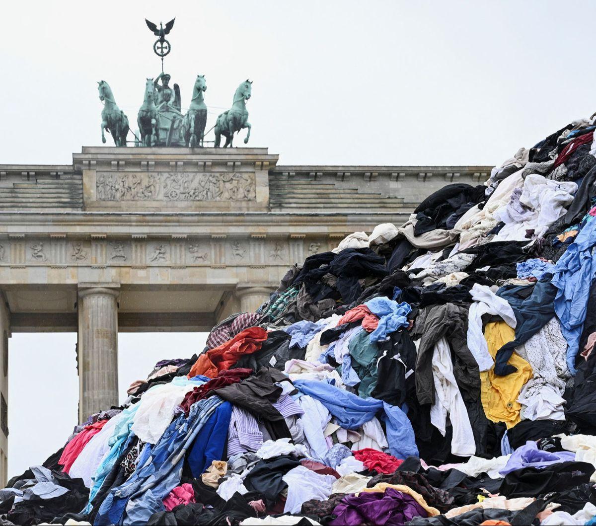 Gunungan sampah pakaian bekas dipajang oleh aktivis lingkungan Greenpeace di depan Gerbang Brandenburg, Berlin, Jerman, pada 5 Februari 2024. Aksi ini dilakukan untuk menentang tren fast fashion yang memiliki dampak buruk bagi lingkungan.&nbsp;REUTERS/Ann