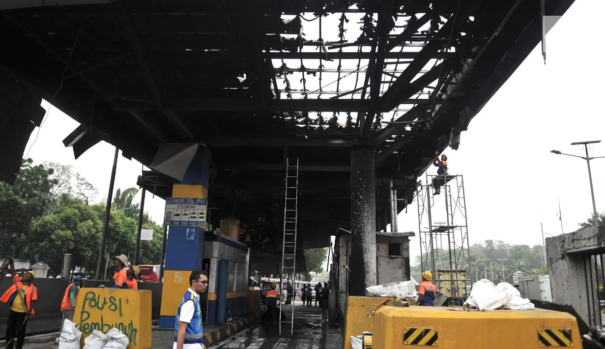 Petugas membongkar puing-puing fasilitas yang hangus terbakar di Gerbang Tol Pejompongan, Jakarta, Rabu (25/9/2019). Aksi demonstrasi menolak RKHUP yang berujung kerusuhan antara pendemo dan polisi menyebabkan Gerbang Tol Pejompongan hangus dibakar massa. (merdeka.com/Iqbal S. Nugroho)
