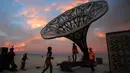 Peserta mengeksplorasi seni instalasi La Victrola dalam Festival Burning Man, yang digelar di padang pasir Black Rock, Nevada, Amerika Serikat. (01/09). Festival seni tahunan digelar 28 Agustus hingga 5 September 2016. (REUTERS/Jim Urquhart)