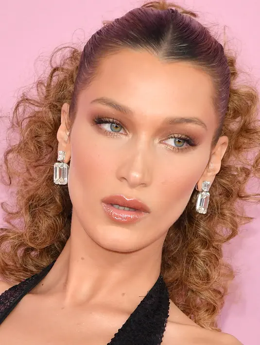 Model Bella Hadid berpose saat menghadiri CFDA Fashion Awards di Brooklyn Museum of Art, New York City (3/6/2019). Bella Hadid tampil seksi mengenakan gaun halter berpayet hitam backless dari Michael Kors Collection dengan hiasan bulu. (AFP Photo/Dimitrios Kambouris)
