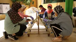 Anak-anak Palestina meletakkan tanaman ke dalam botol plastik di Pusat Anak-Anak Al-Qattan, Gaza City, Senin (20/7/2020). Program ini bernama daur ulang limbah rumah tangga menjadi produk yang ramah lingkungan. (Xinhua/Rizek Abdeljawad)