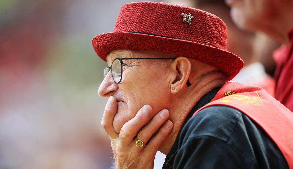 Suporter Manchester United termenung saat menyaksikan tim kesayanganya dipermalukan Brighton and Hove Albion pada laga Liga Inggris di Stadion Old Trafford, Minggu (07/08/2022). (AP/Lindsey Parnaby)
