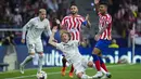 <p>Gelandang Real Madrid, Luka Modric (tengah) terjatuh saat berebut bola dengan pemain Atletico Madrid Reinildo Mandava selama pertandingan lanjutan La Liga Spanyol di stadion Wanda Metropolitano di Madrid, Spanyol, Senin (19/9/2022). Real Madrid menang atas Atletico Madrid 2-1. (AP Photo/Manu Fernandez)</p>