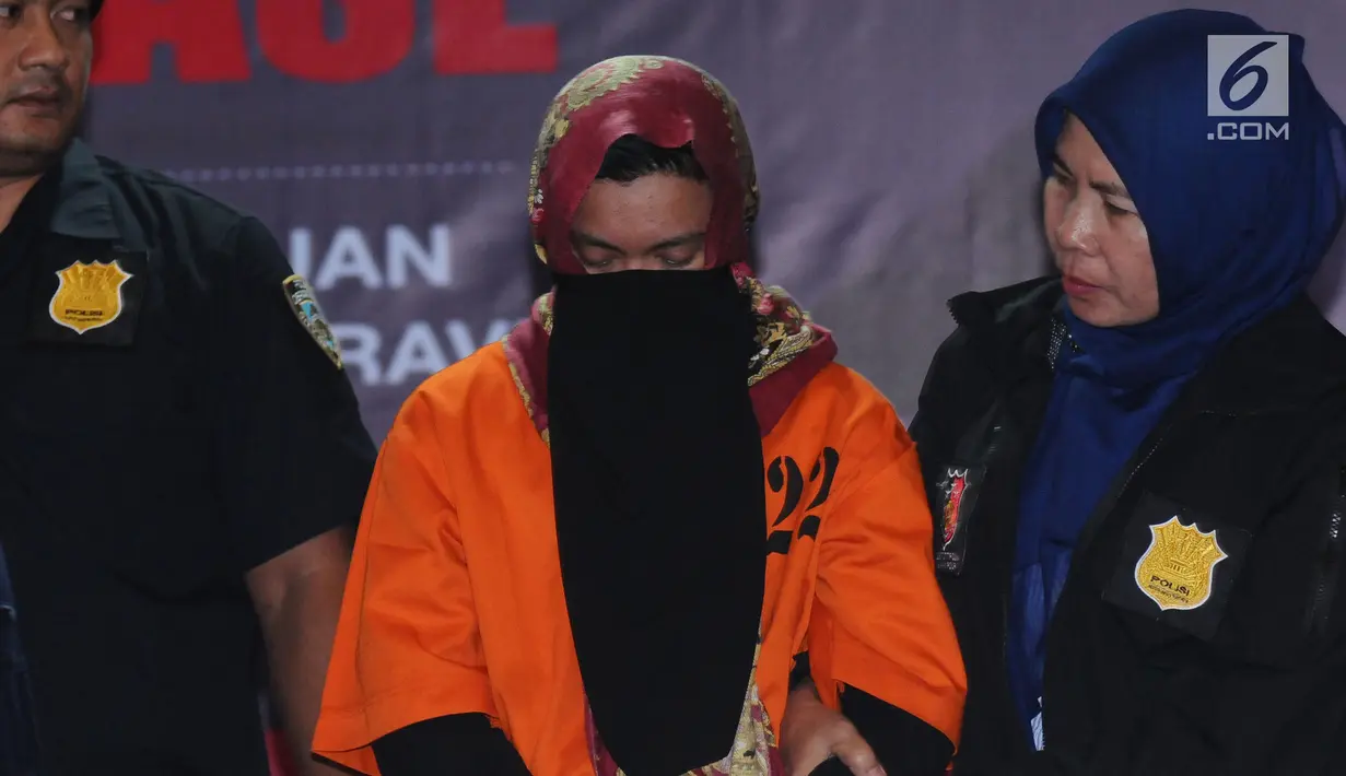 Tersangka kasus penipuan calon jemaah umroh, Kiki Hasibuan menunduk saat diperlihatkan polisi di Bareskrim Mabes Polri, Jakarta, Selasa (22/8). Hingga kini, polisi telah menetapkan tiga tersangka kasus tersebut. (Liputan6.com/Helmi Fithriansyah)