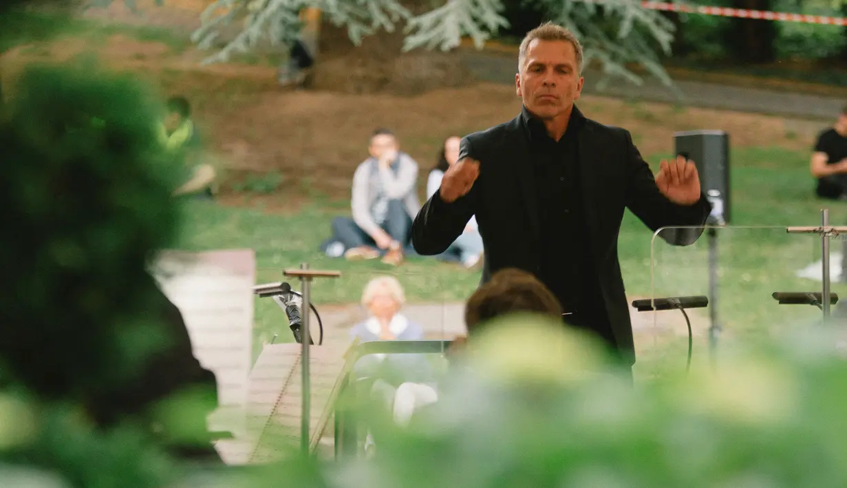 Para musisi dari Beethoven Orchestra Bonn mengadakan konser di sebuah taman di Bonn, Jerman, pada 28 Juni 2020. Penyelenggara acara menyediakan alas piknik bagi para audiens untuk mengingatkan agar tetap menjaga jarak fisik di tengah kekhawatiran penyebaran COVID-19. (Xinhua/Tang Ying)