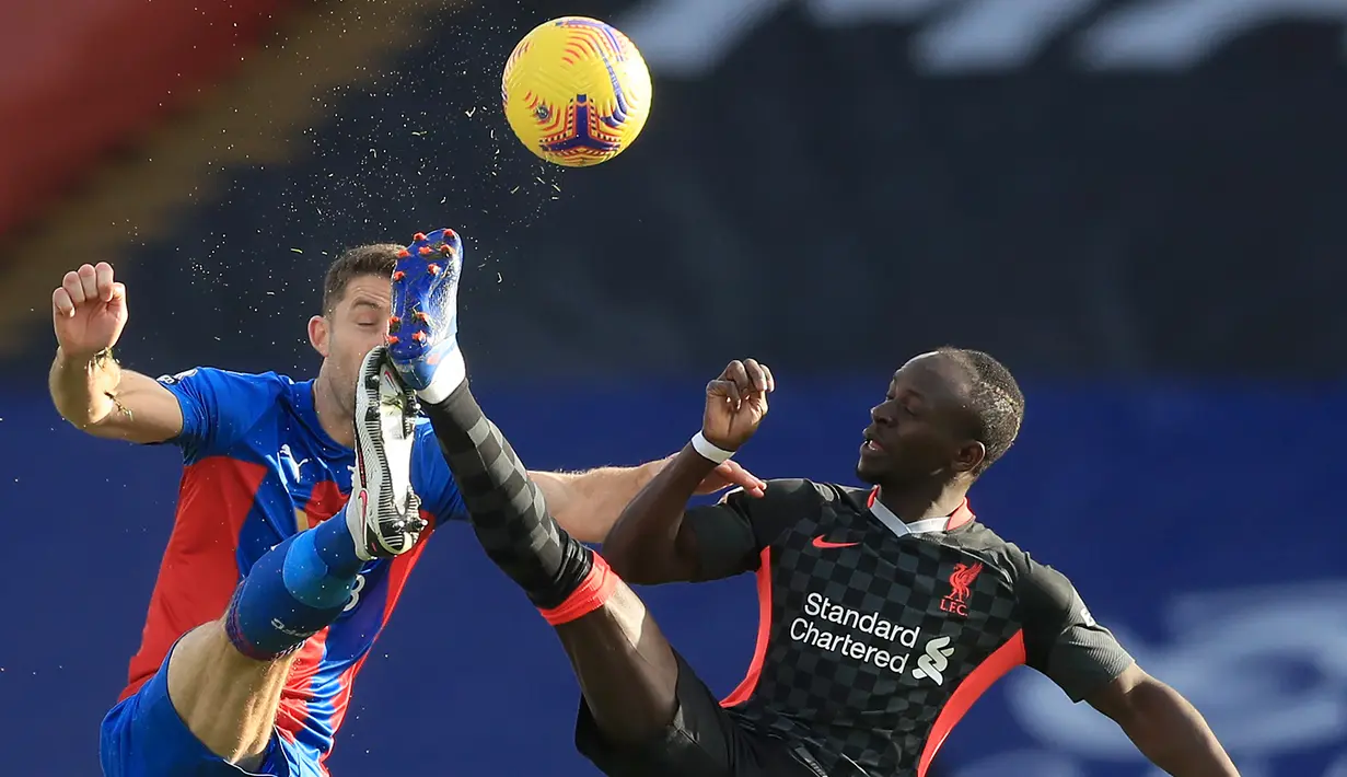 Striker Liverpool, Sadio Mane, berebut bola dengan bek Crystal Palace, Gary Cahill, pada laga lanjutan Liga Inggris di Selhurst Park Stadium, Sabtu (19/12/2020) malam WIB. Liverpool menang 7-0 atas Crystal Palace. (AFP/Adam Davy/pool)