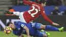 Pemain Manchester United, Henrikh Mkhitaryan (atas) terjatuh saat berebut bola dengan pemain Leicester City, Christian Fuchs pada lanjutan Premier League pekan ke-24 di King Power Stadium, Leicester, (5/2/2017).  MU menang 3-0. (AP/Rui Vieira)