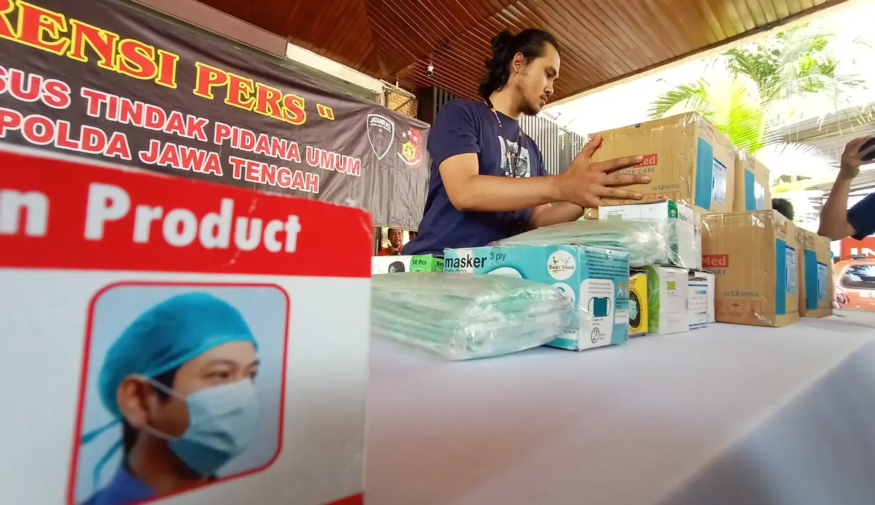 Petugas merapikan masker saat melakukan gelar atas penangkapan  penimbun masker dan hand sanitizer di Polda Jateng, Semarang, Selasa (4/3/2020). Dua orang ditangkap berinisial AK (45) warga Kanalsari Barat, Semarang Timur dan M (24) warga Kapas timur VIII, Genuk Semarang. (Liputan6.com/Gholib)