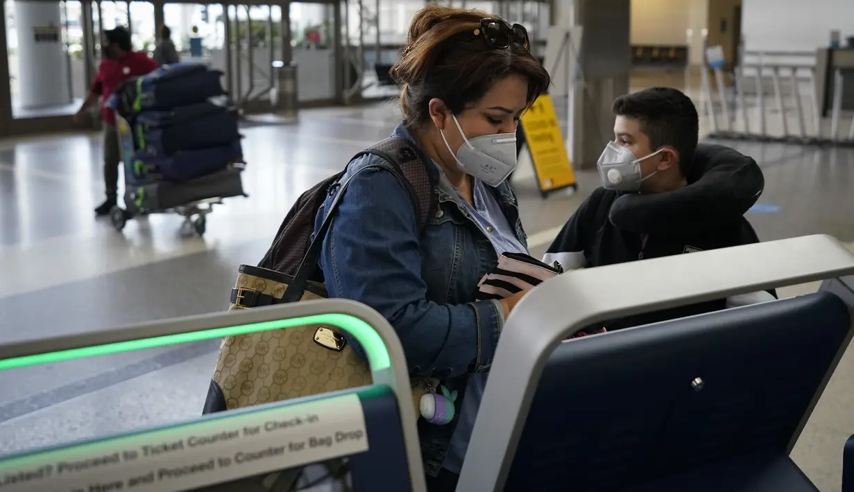 Esmeralda Elizalde melakukan check in penerbangan ke Meksiko di Bandara Internasional Los Angeles di Los Angeles, California, 23 November 2020. Menjelang Thanksgiving, Pusat Pengendalian Penyakit mengimbau agar orang Amerika tak bepergian di tengah lonjakan Covid-19 di AS. (AP Photo/Jae C. Hong)