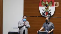 Ketua KPK Firli Bahuri (kiri) bersiap menggelar konferensi pers terkait operasi tangkap tangan (OTT) perkara suap di Mahkamah Agung di gedung KPK, Jakarta, Jumat (23/9/2022). Dalam OTT pada Rabu (21/9/2022) tersebut KPK mengamankan barang bukti uang 205.000 Dollar Singapura dan Rp50 juta yang diduga untuk menyuap pengurusan perkara di Mahkamah Agung. (Liputan6.com/Herman Zakharia)