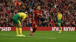 Pada laga pembuka Liga Inggris 2019/2020 antara Liverpool dan Norwich City di Anfield Stadium, Liverpool (9/8/2019), bek Norwich City, Grant Hanley (kiri) mencetak gol bunuh diri pada menit ke-7. Hasil akhir Liverpool menang 4-1. (AFP/Oli Scarff)