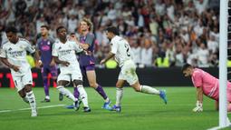 Sempat tertinggal lebih dulu, Los Blancos berhasil menyamakan skor lewat gol Dani Carvajal pada menit ke-58. (Thomas COEX/AFP)