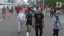 Warga berolahraga di kawasan bundaran HI, Jakarta, Minggu (12/6/2022). Car Free Day di kawasan Sudirman-Thamrin dimanfaatkan warga untuk berolah raga dan ber foto-foto. (Liputan6.com/Herman Zakharia)