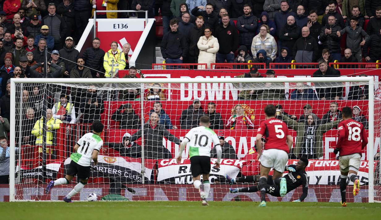Striker Liverpool, Mohamed Salah (kiri) mencetak gol penyeimbang 2-2 ke gawang Manchester United lewat eksekusi penalti pada laga pekan ke-32 Premier League 2023/2024 di Old Trafford Stadium, Manchester, Minggu (7/4/2024). (AP Photo/Dave Thompson)
