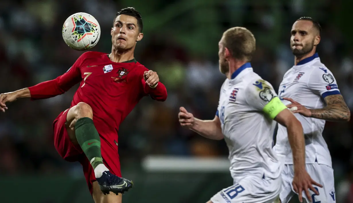 Cristiano Ronaldo, saat berebut bola dengan bek Luksemburg pada pertandingan kualifikasi Euro 2020 antara Portugal melawan Luksemburg di Stadion Jose Alvalade, Lisbon, 11 Oktober 2019. (AFP/Carlos Costa)
