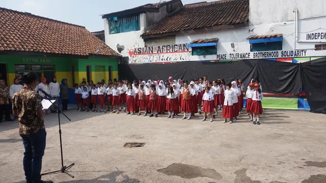 Puluhan siswa SD 249 Astana Anyar mengikuti upacara peringatan KAA ke-63 di halaman Aula RW 05 Lio Genteng, Kelurahan Nyengseret, Kecamatan Astana Anyar, Kota Bandung.