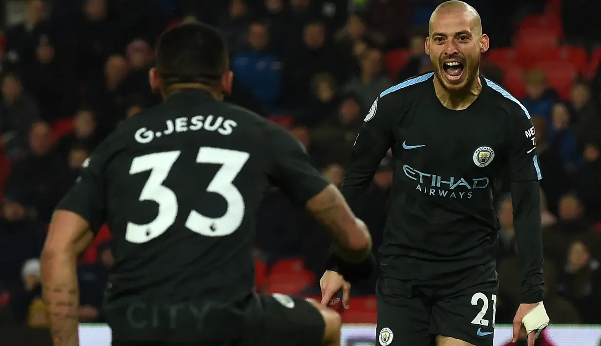 Gelandang Manchester City, David Silva merayakan gol ke gawang Stoke City pada pertandingan pekan ke-30 Premier League di bet365 Stadium, Selasa (13/3). David Silva menjadi pahlawan dengan memborong dua gol kemenangan Manchester City. (PAUL ELLI/AFP)