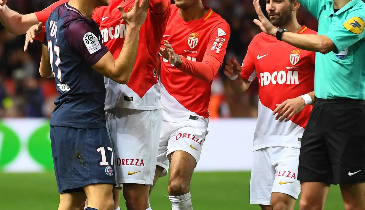 Pemain PSG, Yuri Berchiche menerima kartu kuning setelah melanggar pemain AS Monaco, Djibril Sidibe pada lanjutan Ligue 1 di Louis II stadium, Monaco, (26/11/2017). PSG menang 2-1. (AFP/Anne-Christine Poujoulat)