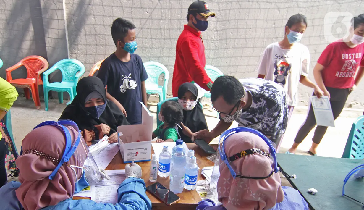 Petugas mendata warga sebelum melakukan tes usap PCR Covid-19 di Jalan As-Syafiiyah, Cipayung, Jakarta Timur, Jumat (21/5/2021). Kawasan tersebut memberlakukan mikro lockdown serta tes usap PCR secara massal. (Liputan6.com/Herman Zakharia)