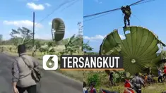 Masyarakat langsung berbondong-bondong membantu penerjun payung terbawa angin dan tersangkut kabel.