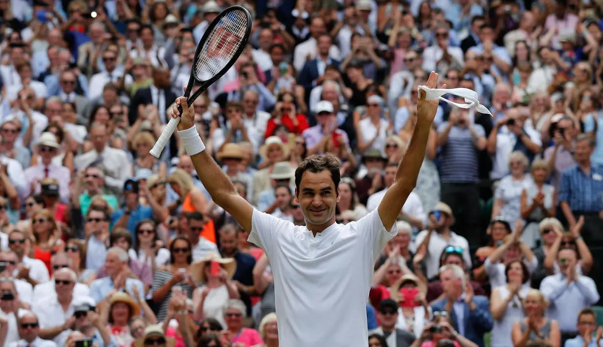Petenis Swiss, Roger Federer merayakan kemenangan setelah melawan petenis Kroasia, Marin Cilic pada pertandingan final tunggal putra Kejuaraan Wimbledon 2017 di Wimbledon, London. (16/07). Roger Federer menang 6-3, 6-1, 6-4. (AFP Photo / Adrian Dennis)