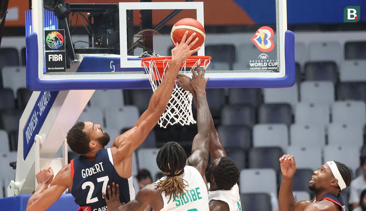 Pebasket Prancis, Rudy Gobert, berusaha memblok bola saat melawan Pantai Gading pada pertandingan FIBA World Cup 2023 di Indonesia Arena, Sabtu (2/9/2023). Prancis menang dengan skor 87-77. (Bola.com/M Iqbal Ichsan)