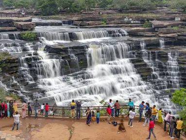 Orang-orang berfoto di depan Air Terjun Rajdari pada hari musim panas yang terik di distrik Chandauli, negara bagian Uttar Pradesh, India (28/6/2021).  Air Terjun Rajdari adalah tempat piknik yang populer bagi orang-orang di sekitar area tersebut pada musim panas. (AP Photo/Rajesh Kumar Singh)