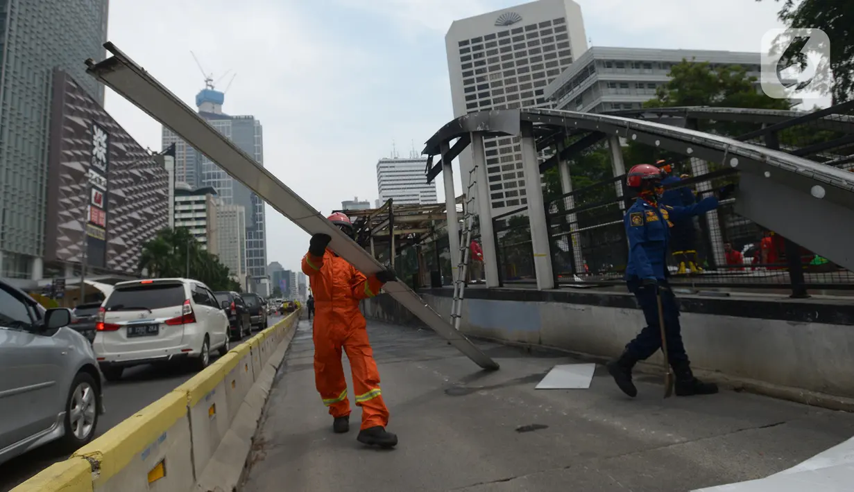 Sejumlah petugas membersihkan puing Halte Transjakarta Tosari imbas unjuk rasa menolak Omnibus Law UU Cipta Kerja di Jalan M.H. Thamrin, Jakarta, Sabtu (10/10/2020). Wagub DKI Jakarta Ahmad Riza Patria memperkirakan kerugian imbas ujuk rasa tersebut mencapai Rp.65 miliar. (merdeka.com/Imam Buhori)