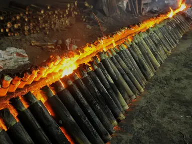 Proses pembakaran lemang di sentra pembuatan lemang kawasan Kramat Raya, Senen, Jakarta, Jumat (17/6). Pembuatan lemang pada bulan Ramadan meningkat lebih dari 300 persen dibanding hari biasa hingga mencapai 500 buah per-hari (Liputan6.com/Gempur M Surya)