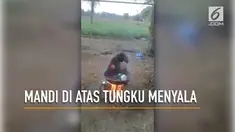 Seorang bocah nekat mandi di wajan besar di atas tungku api yang menyala,