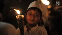 Seorang anak membawa obor saat pawai Tahun Baru Islam 1440 H di Menteng, Jakarta, Senin (10/9). Pawai obor yang diiringi musik bernuansa Islam merupakan tradisi umat muslim di Indonesia menyambut Tahun Baru 1 Muharram. (Merdeka.com/Iqbal S Nugroho)