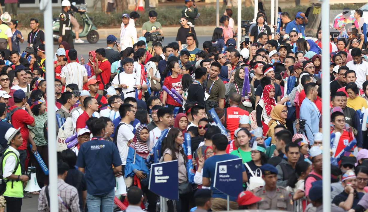 Calon penonton antre untuk masuk menyaksikan laga final Bulutangkis Beregu Putra di Istora Senayan Jakarta, Rabu (22/8). Laga final bulu tangkis beregu putra mempertemukan Indonesia melawan China. (Liputan6.com/Helmi Fithriansyah)