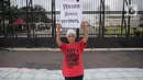 Salah satu peserta aksi yang tergabung dalam Koalisi Sipil Untuk UU Perlindungan PRT mengangkat poster di depan Gedung DPR, Jakarta, Rabu (15/7/2023). Dalam aksinya, pendemo yang sebagian besar ibu-ibu ini juga membawa spanduk dan poster berisi tuntutan mereka. (Liputan6.com/Faizal Fanani)