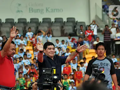 Legenda sepak bola Argentina Diego Maradona (tengah) menyapa penggemarnya saat datang ke Stadion Gelora Bung Karno (GBK), Senayan, Jakarta, Sabtu (29/6/2013). Diego Maradona dikabarkan meninggal dunia karena serangan jantung. (Liputan6.com/Helmi Fithriansyah)