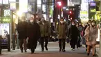 Orang-orang memakai masker untuk melindungi dari penyebaran virus corona berjalan di sepanjang jalan yang dipenuhi bar dan restoran di Tokyo, Rabu (19/1/2022). Tokyo dan puluhan daerah lain di Jepang akan menghadapi pembatasan COVID-19 baru yang berlaku efektif Jumat (21/1). (AP Photo/Koji Sasahara)