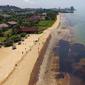 Gambar dari udara tumpahan minyak di Pantai Kemala, Balikpapan, Kalimantan Timur, Senin (2/4). Pipa bawah laut Pertamina pecah akibat tersangkut jangkar kapal pengangkut batu bara. (AFP)