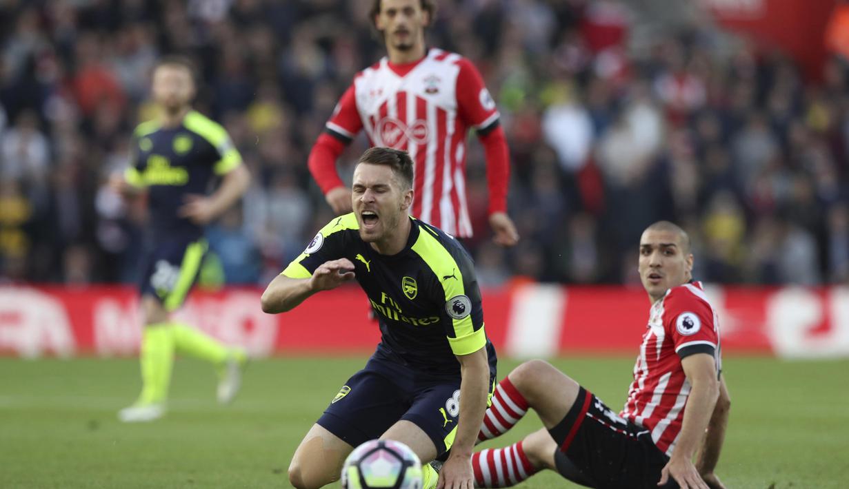 Pemain Southampton, Oriol Romeu (kanan) melakukan pelangaran terhadap pemain Arsenal, Aaron Ramsey pada laga Premier League di St Mary's stadium, Southampton, (10/5/2017). Arsenal menang 2-0. (AP/Alastair Grant)
