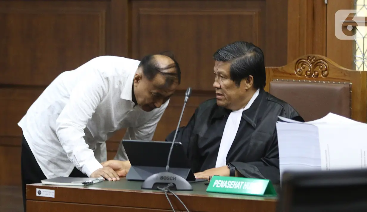 Terdakwa kasus korupsi proyek KTP Elektronik Markus Nari berbincang dengan kuasa hukumnya saat menjalani sidang lanjutan di Pengadilan Tipikor, Jakarta, Senin (28/10/2019). Sidang tersebut beragenda tuntutan dari JPU, Markus Nari dituntut 9 tahun dan denda Rp 900 juta. (Liputan6.com/Herman Zakharia)