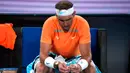 Reaksi petenis Spanyol Rafael Nadal setelah kalah dari petenis Amerika Serikat Mackenzie McDonald pada pertandingan putaran kedua kejuaraan tenis Australian Open di Melbourne, Australia, Rabu (18/1/2023). Rafael Nadal harus tersingkir dari Australian Open 2023 setelah ia mengalami cedera dan kemudian takluk 4-6, 4-6, 5-7 dari petenis Amerika Serikat MacKenzie McDonald. (AP Photo/Dita Alangkara)