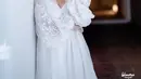Sebelum tampil berkebaya, Kiki mengenakan robe putih organza dengan aksen lace pada bagian lengan. [Instagram/windrafotografi].
