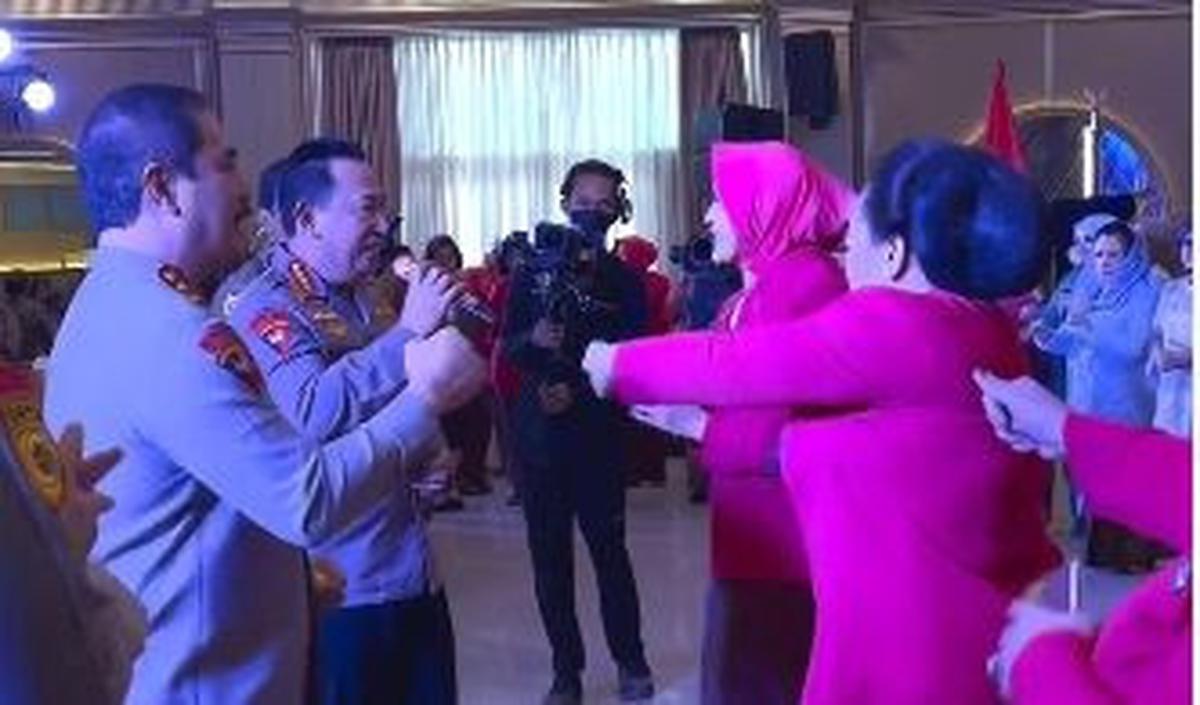 Di hadapan mereka berdiri para istri yang mengenakan seragam Bhayangkari berwarma merah muda.
