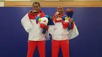 Agus Domosarjito (kiri) meraih medali emas dan Totok Tri Martanto (kanan) merebut podium kedua cabor menembak nomor air pistol silhouette SEA Games 2019. (PB Perbakin)