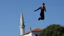 Seorang peserta melompat dari jembatan saat mengikuti acara kompetisi menyelam tradisional ke 451 di Mostar, Bosnia, Minggu (30/7). Total 41 peserta dari Bosnia dan negara-negara tetangga mengikuti kompetisi menyelam tahunan tersebut (AP Photo/Amel Emric)