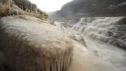 Foto pada 9 Desember 2020 ini menunjukkan pemandangan musim dingin objek wisata Air Terjun Hukou di wilayah Jixian, Provinsi Shanxi, China utara. Air terjun Hukou terletak di daerah perbatasan antara Provinsi Shanxi di China utara dan Provinsi Shaanxi di China barat laut. (Xinhua/Lyu Guiming)